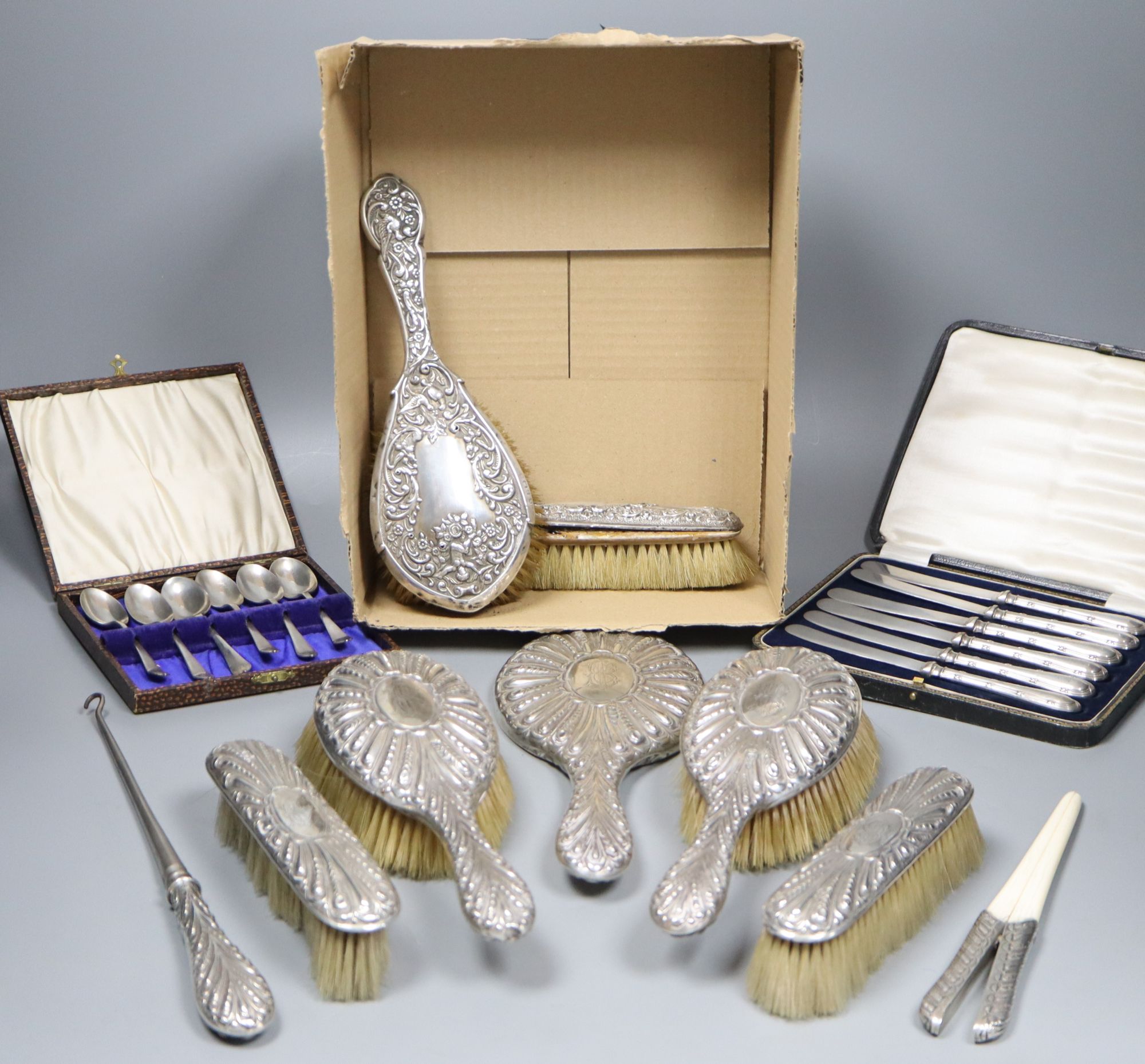 A late Victorian repousse silver mounted seven piece dressing table set by William Comyns, London, 1897/8, etc.